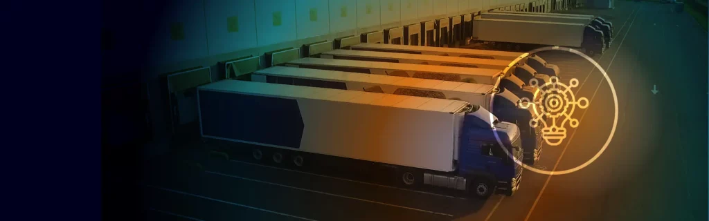 Six trucks parked at loading bays outside a warehouse